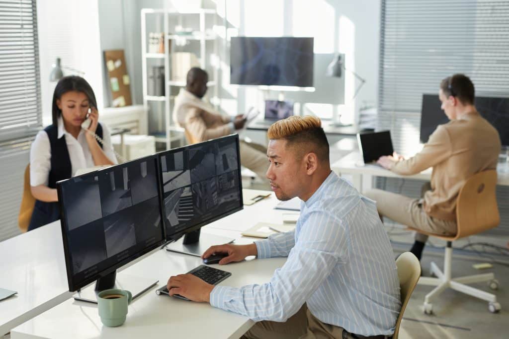 Office workers on their phones and computers.